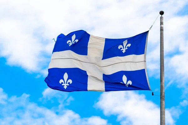 Montreal, Canada: Flag of Quebec province flying waving in the air in clear sky day