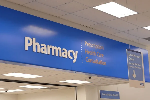 Close up of pharmacy sign hanging on store