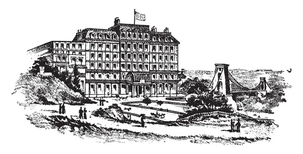 五层高的克利夫顿酒店及其附近的一座桥位于 复古线条画或雕刻插图 — 图库矢量图片