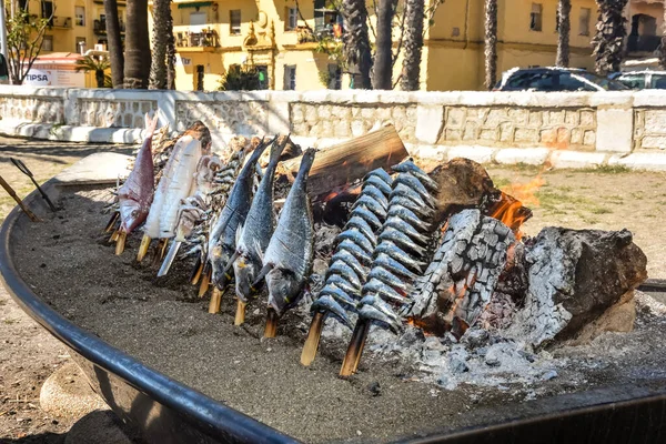 Sardine and Sea bream fish grilled over a wood fire in Malaga in Spain