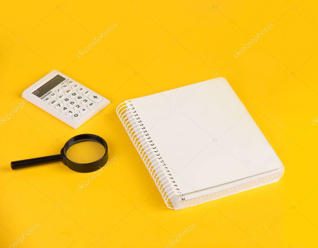 Notebook and stationery on yellow background