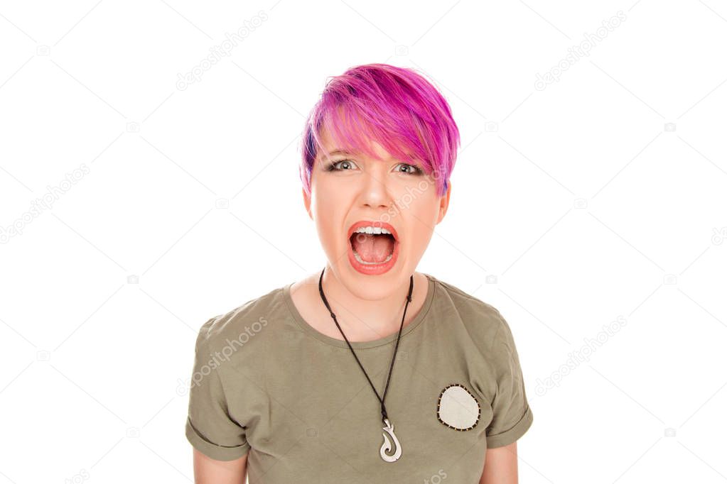 Young woman screaming in terror mouth wide open looking in panic at the camera. Close up portrait of irritated female shouting, yelling looking at you camera angry isolated white background in studio.