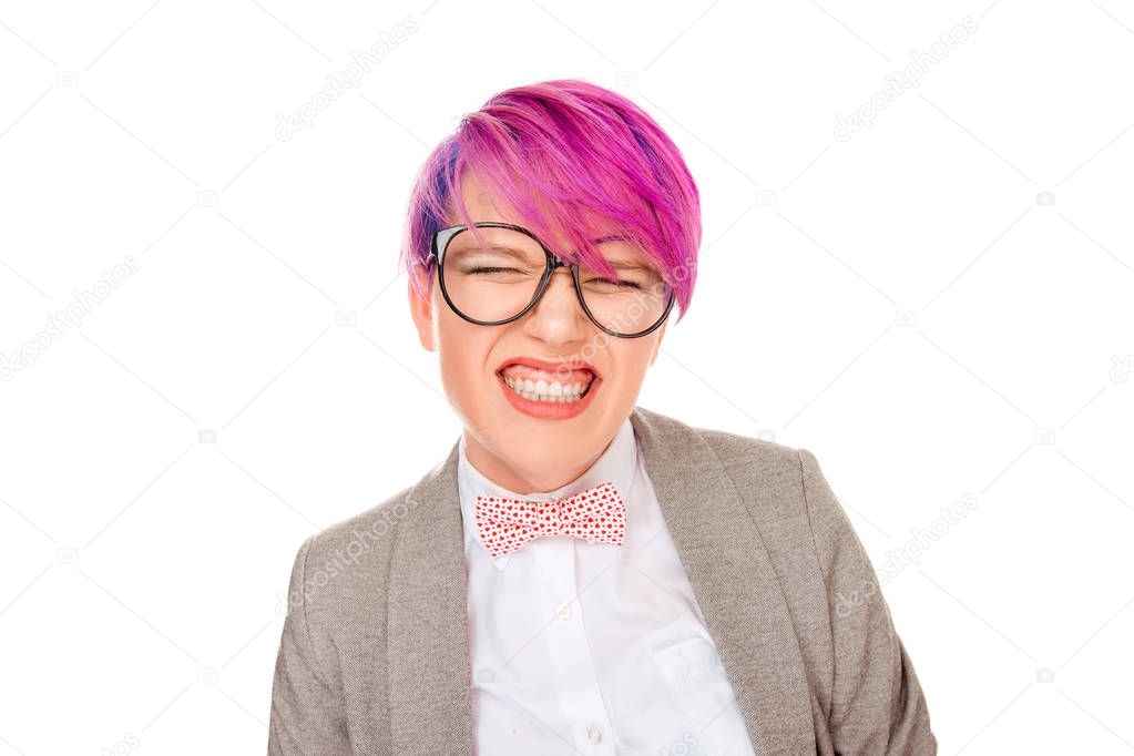 Disgusted woman with pink hair pursing her lips and making a funny face showing white teeth isolated on white background. Studio shot horizontal image. Negative facial expressions human face emotions.