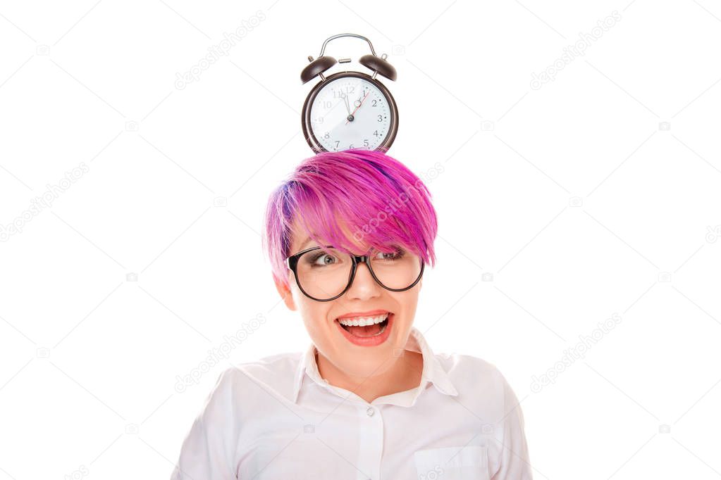 Young excited woman female girl with pink hair holding a clock on her head isolated on white background. Happy in time concept. Positive facial expressions human face emotions body language reaction.