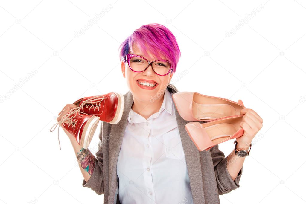 Girl with two pairs of new shoes isolated on white background. Woman holding in one hand high heels and other flat shoes smiling happy, she loves both pairs. Positive human facial emotion, face expression, feeling