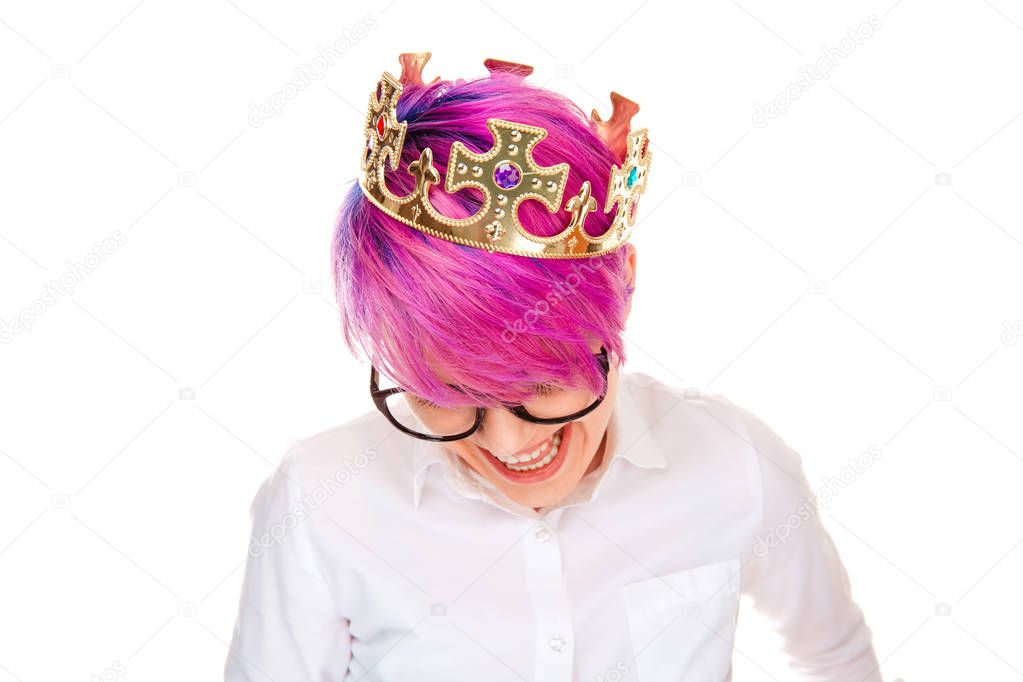 Jubilee. The happy beautiful woman wearing birthday party golden crown laughing happy smiling toothy isolated on white background wall. Girl with full makeup pink short hair formal buttoned shirt.