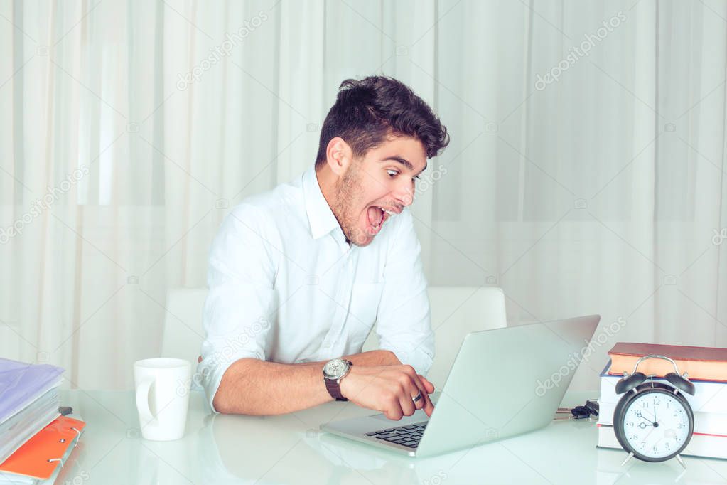 Man working on computer ready press delete enter button isolated white green office background. Funny funky crazy looking boy excited what she see on laptop screen browsing internet. Face expression