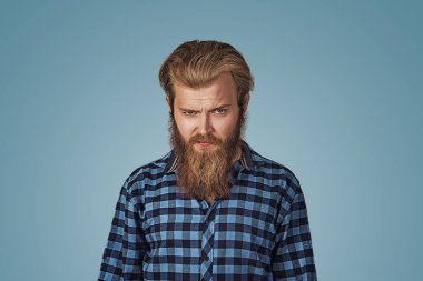 Closeup kızgın, sinirli, huysuz, deli adam portresi. Kötü tutum, Kişilik, kişilerarası uyuşmazlık çözümü, istihbarat. Mavi ekose kareli gömlekli göl kenarında mavi sakallı hippi erkek