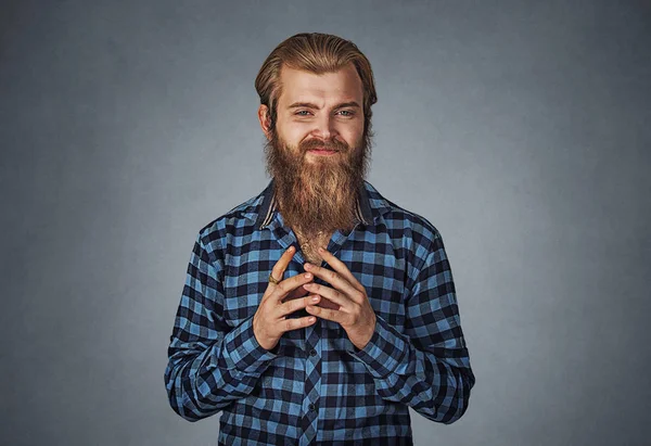 Bir şey komplo sinsi entrikacı genç adam. Mavi Kareli sakallı hippi erkek gömlek Isolated gri gri studio arka plan üzerinde kareli. Negatif yüz ifadesi, insan duygu, beden dili.