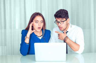 Şok haber. İki çift iş arkadaşlarınızın arkadaşları erkek ve kadın evde oturma odasında office masada oturan dizüstü bakarak şok şaşırttı. Serbest çalışma şok hayran işçi kavramı hayrete