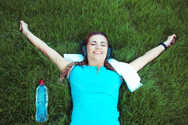 woman giving winner hands gesture lying down