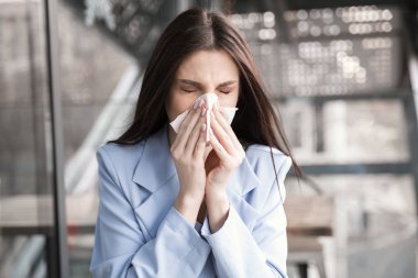 Flu. Young woman got nose allergy, flu sneezing nose. clipart
