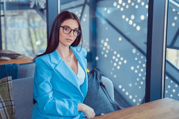 güzel kadın bir kahve dükkanında kameraya bakarak poz