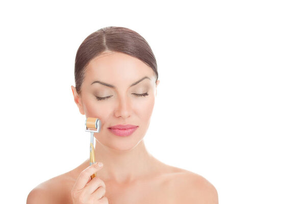 Beauty girl using skin anti aging needles roller.
