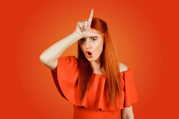 Woman giving loser sign on forehead — Stock Photo, Image