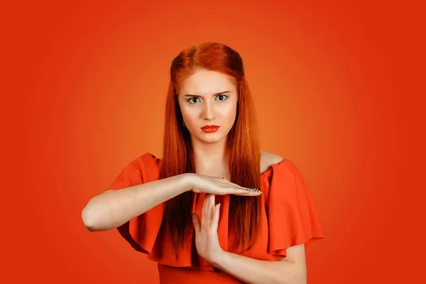 Serious young woman in showing sign of time-out — Stock Photo, Image