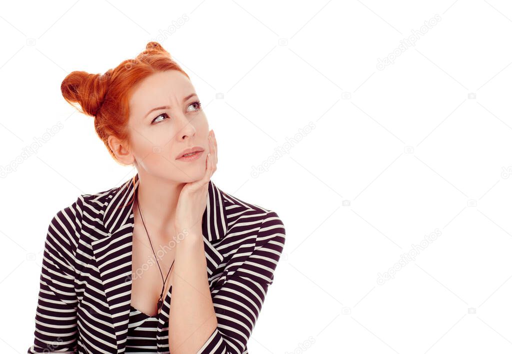 Thoughtful. Closeup portrait of a cut out beautiful woman in her 30s looking up to side copyspace pensive wearing striped black white jacket with 2 buns up hairdo isolated on pure white background