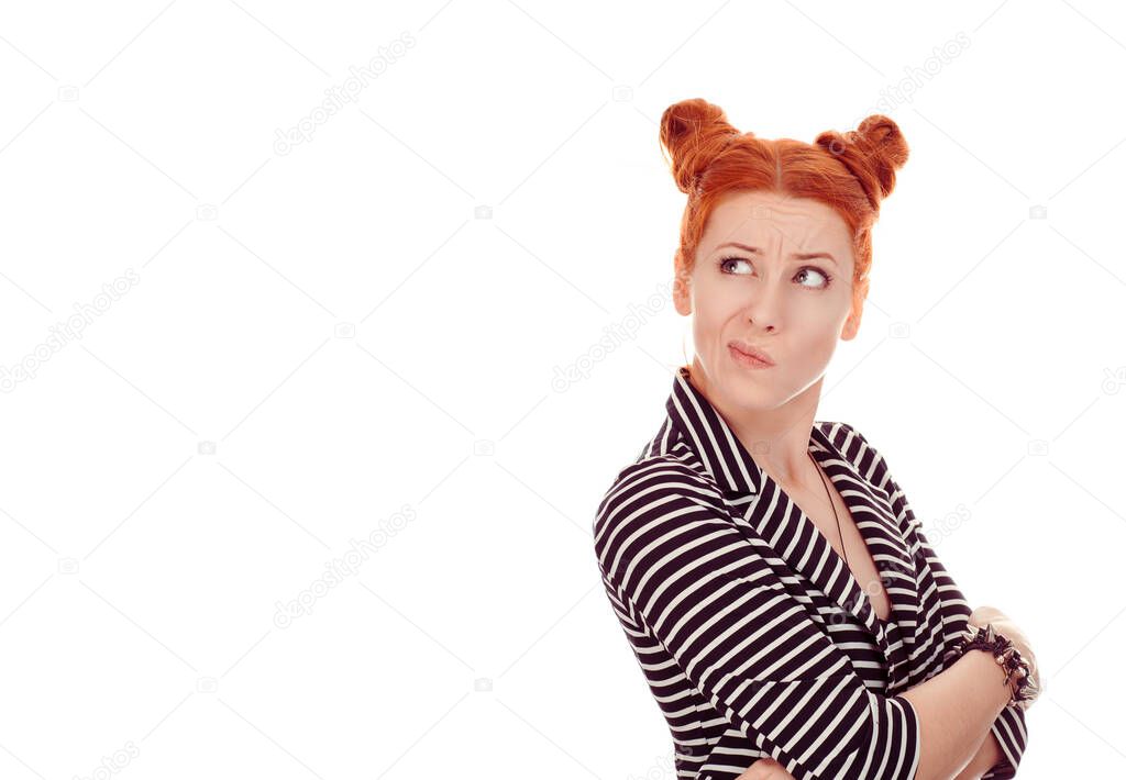 Skeptical looking up. Closeup portrait cut out of beautiful woman having doubts looking to copyspace up wearing striped black white jacket with 2 buns up hairdo isolated on pure white background wall
