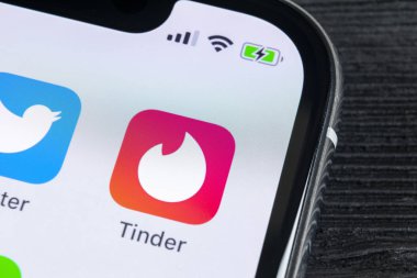 Sankt-Petersburg, Russia, April 27, 2018: Tinder application icon on Apple iPhone X screen close-up. Tinder app icon. Tinder application. Social media icon. Social network.  clipart