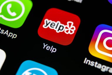Sankt-Petersburg, Russia, May 10, 2018: Yelp application icon on Apple iPhone X screen close-up. Yelp app icon. Yelp.com application. Social network. Social media clipart