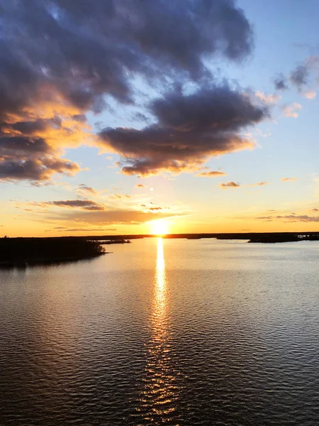 Aerial view of a Sunset sky background. Aerial Dramatic gold sunset sky with evening sky clouds over the sea. Stunning sky clouds in the sunset. Sky landscape. Aerial photography.