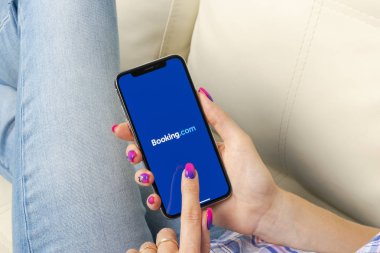 Sankt-Petersburg, Rusya, 30 Mayıs 2018: Booking.com uygulama simgesi ekran yakın çekim kadın elinde X Apple iPhone'da. Rezervasyon app simgesi. Booking.com. sosyal medya app. sosyal ağ