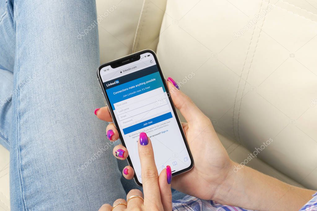 Sankt-Petersburg, Russia, May 30, 2018: Linkedin homepage on Apple iPhone X screen close-up in woman hands. Linkedin app icon. linkedin.com.  Social media app. Social network