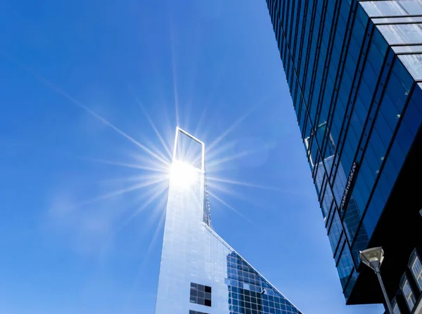 Details of office building exterior. Business buildings skyline looking up with blue sky. Modern architecture apartment. High tech exterior. Reflective buildings. Office Skyscraper. Glass office.