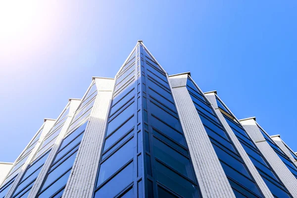 Details of office building exterior. Business buildings skyline looking up with blue sky. Modern architecture apartment. High tech exterior. Reflective buildings. Office Skyscraper. Glass office.