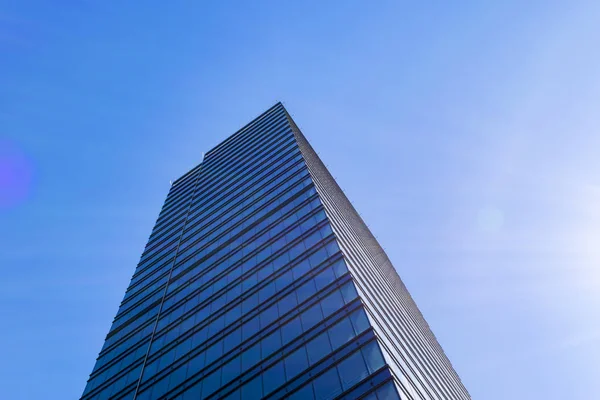 Details of office building exterior. Business buildings skyline looking up with blue sky. Modern architecture apartment. High tech exterior. Reflective buildings. Office Skyscraper. Glass office.