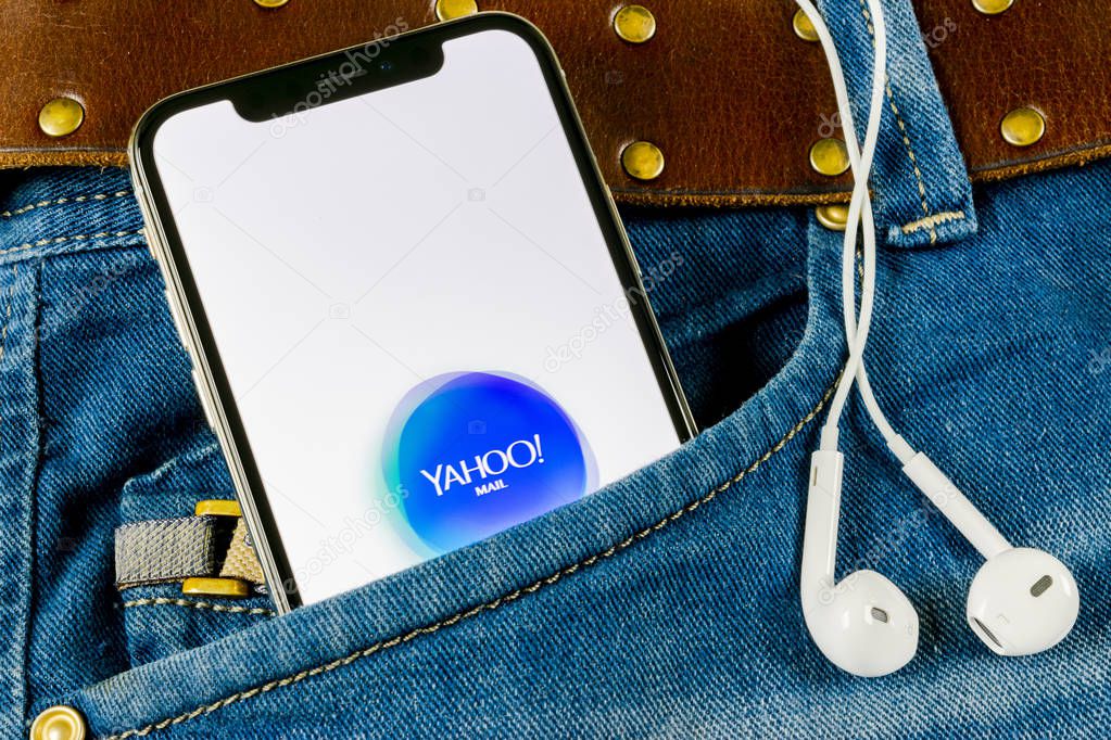 Sankt-Petersburg, Russia, April 14, 2018: Yahoo Mail application icon on Apple iPhone X smartphone screen close-up in jeans pocket. Yahoo mail app icon. Social network. Social media icon