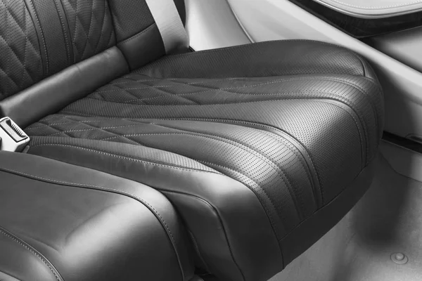 Modern Luxury car inside. Interior of prestige modern car. Comfortable leather seats. Perforated leather with isolated Black background. Modern car interior. Car detailing. Black and white