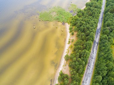 Havadan görünümü karayolu. Köy yolunda göl yakınındaki hava görünümünü. Tarafından geçen araba. Hava yolu. Uçan hava görünümünü. Yukarıdan bir dron ile ele geçirdi. Yumuşak aydınlatma