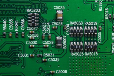 Bir devre panosunun makro görüntüsü, rezistanslı mikroçipler ve elektronik bileşenler. Bilgisayar donanım teknolojisi. Entegre iletişim işlemcisi. Bilgi mühendisliği. Yarı iletken. PCB. Yakın çekim.