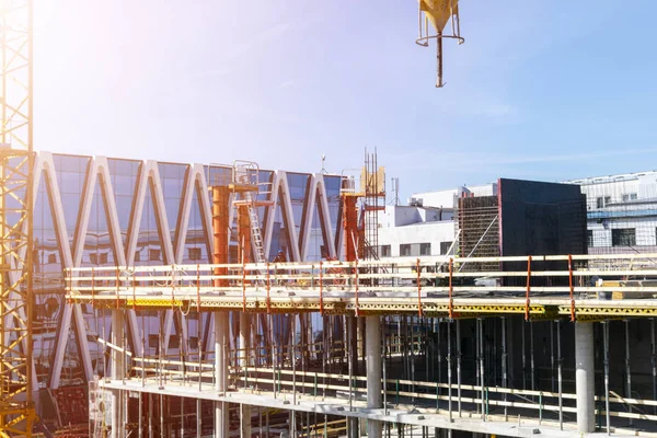 Construction crane tower on blue sky background. Crane and building working progress. Worker. Empty Space for text. Construction concept. Site. New buildings with a crane. Tower crane