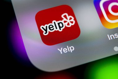 Sankt-Petersburg, Russia, August 16, 2018: Yelp application icon on Apple iPhone X screen close-up. Yelp app icon. Yelp.com application. Social network. Social media clipart