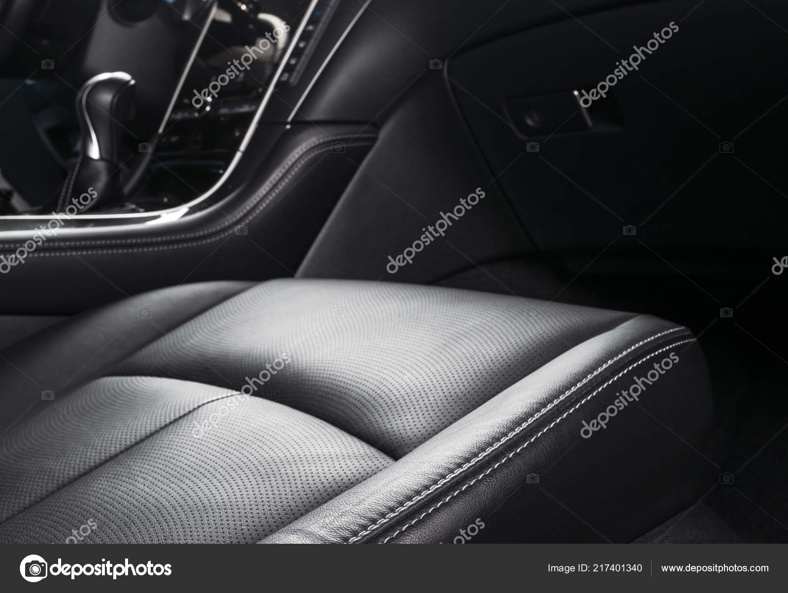 Red perforated leather driver seat with stitching inside luxury car  interior Stock Photo