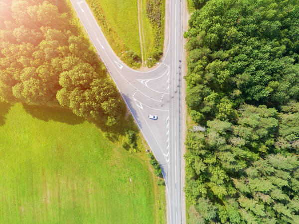 Aerial view of highway in city. Cars crossing interchange overpass. Highway interchange with traffic. Aerial bird's eye photo of highway. Expressway. Road junctions. Car passing. Top view from above. Cars in motion