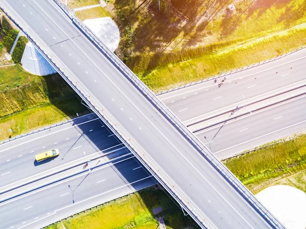 Aerial view of highway in city. Cars crossing interchange overpass. Highway interchange with traffic. Aerial bird's eye photo of highway. Expressway. Road junctions. Car passing. Top view from above.