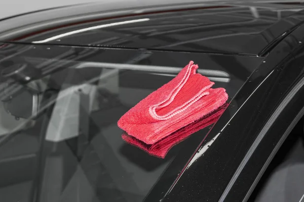 A man cleaning car with microfiber cloth. Car detailing (or valeting) concept. Car detailing. Cleaning with sponge. Car Worker cleaning with Microfiber. Solution to clean