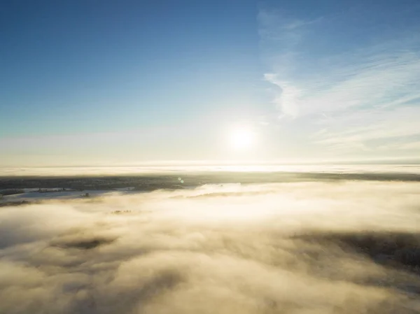 Aerial view clouds over forest during winter colors. Aerial view of forest and clouds. Coastline. Aerial drone view of the forest. Aerial top view cloudscape. Texture of clouds.