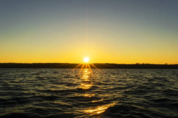 Sunset sky background. Dramatic gold sunset sky with evening sky clouds over the sea. Stunning sky clouds in the sunrise. Sky landscape. Panoramic sky view.