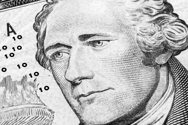 Close up view Portrait of Alexander Hamilton on the one ten dollar bill. Background of the money. 10 dollar bill with Alexander Hamilton eyes macro shot. Money background. Face portrait. Balck and white