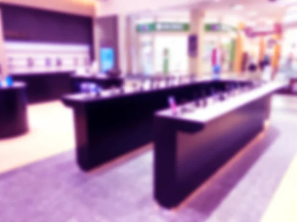 Abstract blur background with mobile store boutique in shopping mall. Electronic department store interior with bokeh light blurred background. Defocused blur background.  Blurry interior view retail shop — Stock Photo, Image