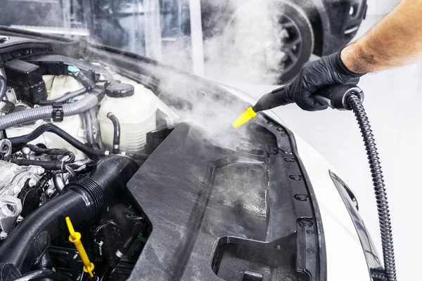 Car detailing. Car washing cleaning engine. Cleaning car using hot steam. Hot Steam engine washing. Soft lighting. Car washman worker cleaning vehicle. — Stock Photo, Image