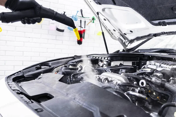 Car detailing. Car washing cleaning engine. Cleaning car using hot steam. Hot Steam engine washing. Soft lighting. Car washman worker cleaning vehicle. — Stock Photo, Image