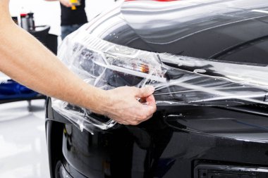 Araba kaydırma uzman vinil folyo ya da film araba koyarak. Koruyucu film araba. Koruyucu film araçları ile araba uygulamak. Araba ayrıntılı. Şeffaf film. Araç boya koruma. Kırpma