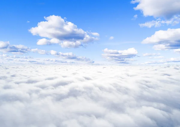 Aerial view White clouds in blue sky. Top view. View from drone. Aerial bird\'s eye view. Aerial top view cloudscape. Texture of clouds. View from above. Sunrise over clouds