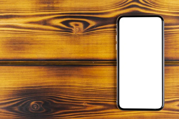 Smartphone ile boş perde kadar sahte. Smartphone izole ekran kırpma yoluyla. Cep telefonu beyaz ekran ile kopya alanı ofis masasında. Metin için boş yer. İzole beyaz ekran