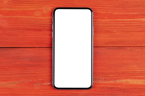 Smartphone with blank screen mock up. Smartphone isolated screen with clipping path. Mobile phone white screen with copy space on office desk. Empty space for text. Isolated white screen